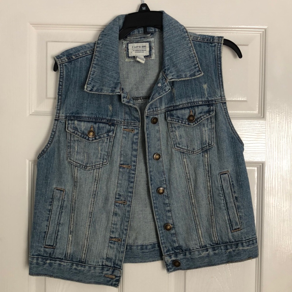 Sleeveless distressed jean jacket.